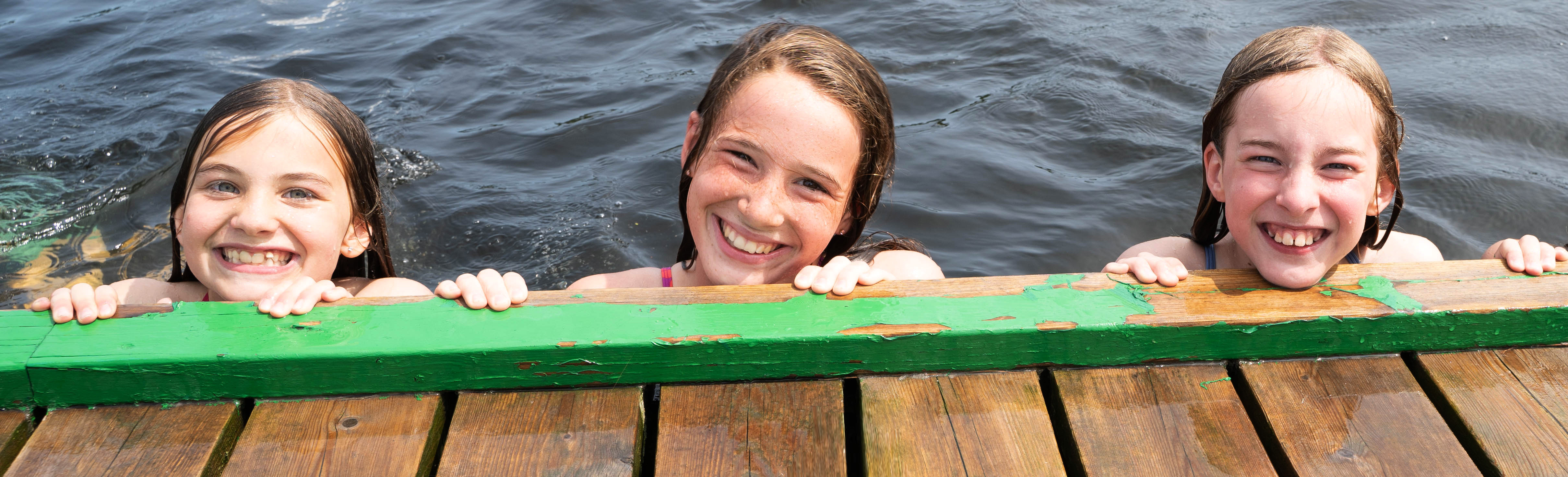 Girls swimming off the rocky shores of Beausoleil Island in Georgian Bay Islands National Park, YMCA Camp Queen Elizabeth 