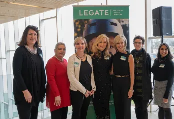 Seven of the 2019 Women of Excellence pose at a media event.