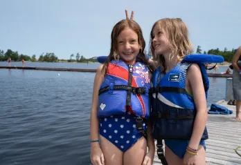 Two campers by lake having fun