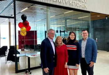 Bierbaum Family stands in front of Community Kitchen