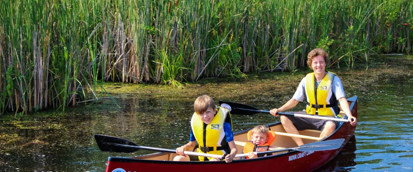 family in canoe at Camp Henry