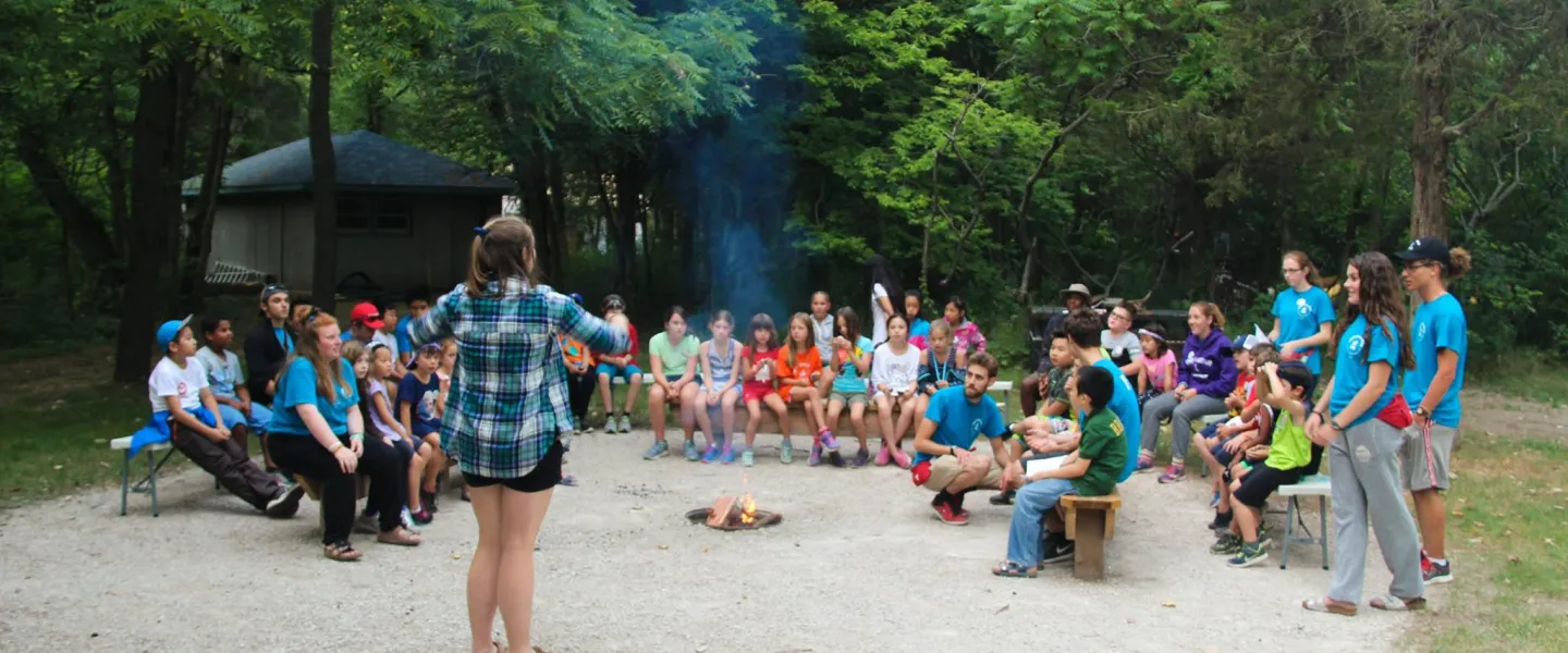 group around the campfire at Camp Henry
