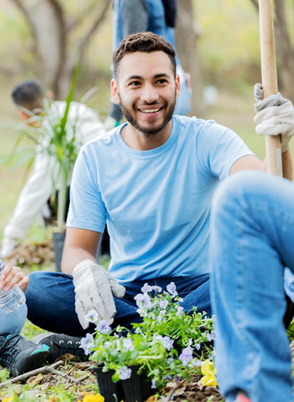 Man and Women helping plant a community garden
