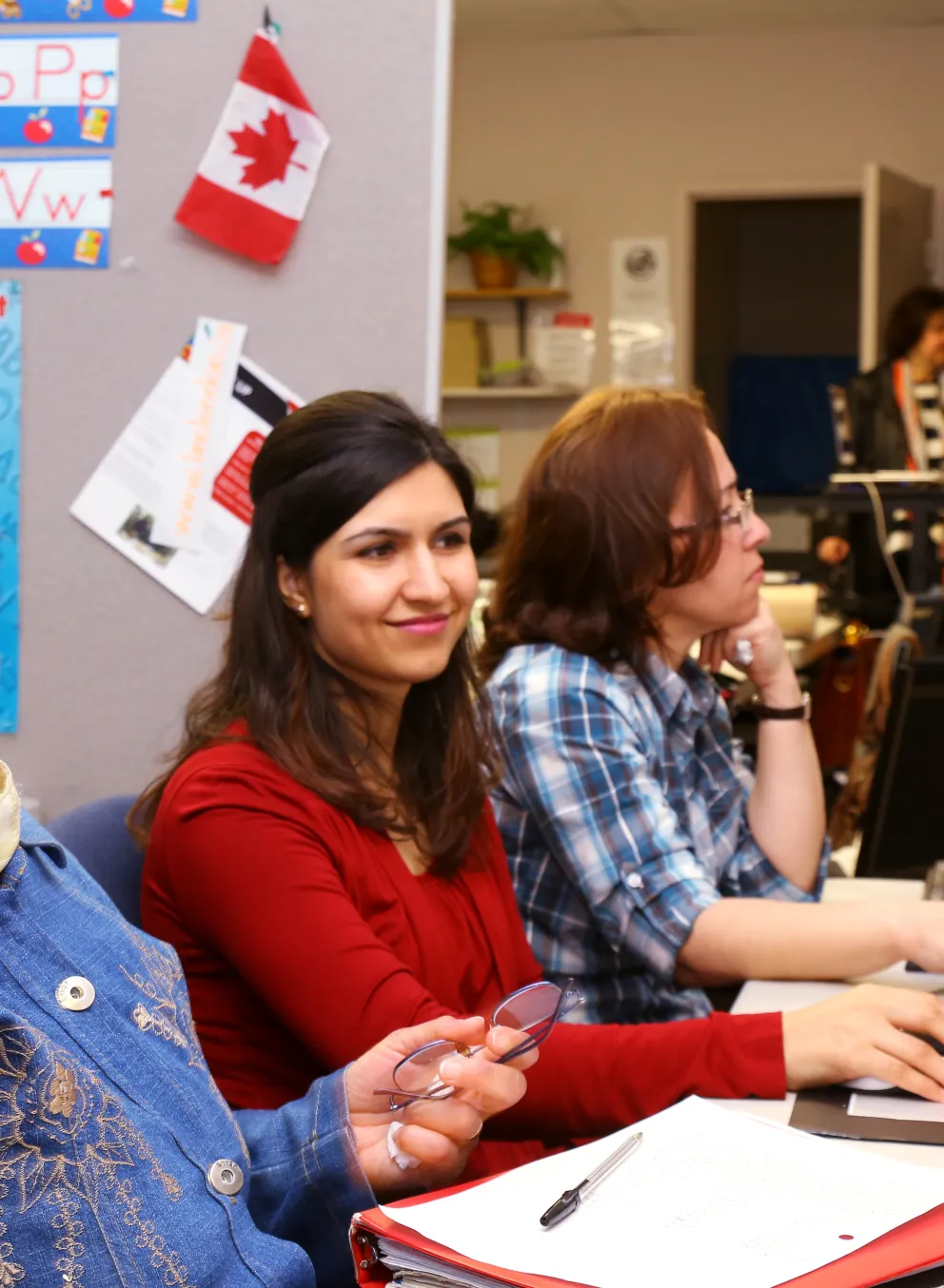 Newcomer ladies learning on computers