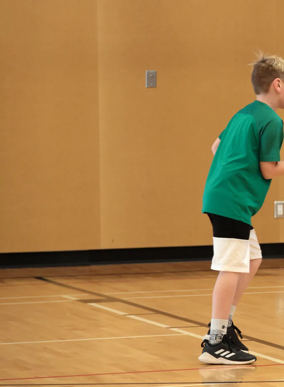Two boys playing basketball in a gym