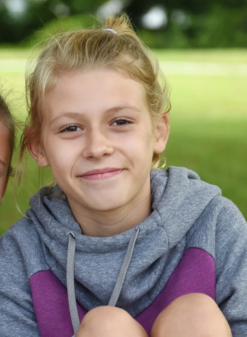 Two girls sitting on the grass at Camp