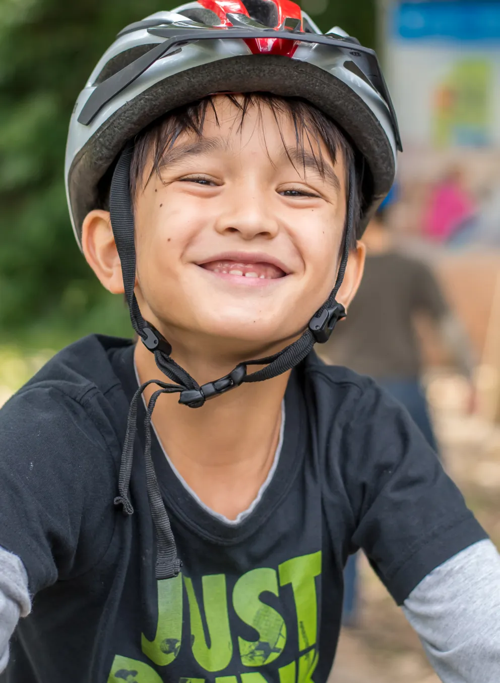 Smiling boy getting ready to ride his bike at Camp Henry
