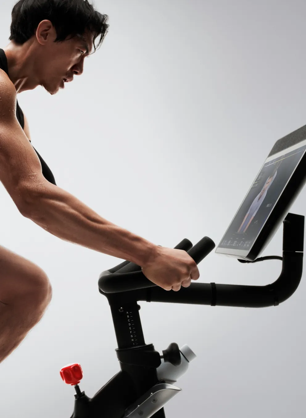 Man riding a Peloton bike