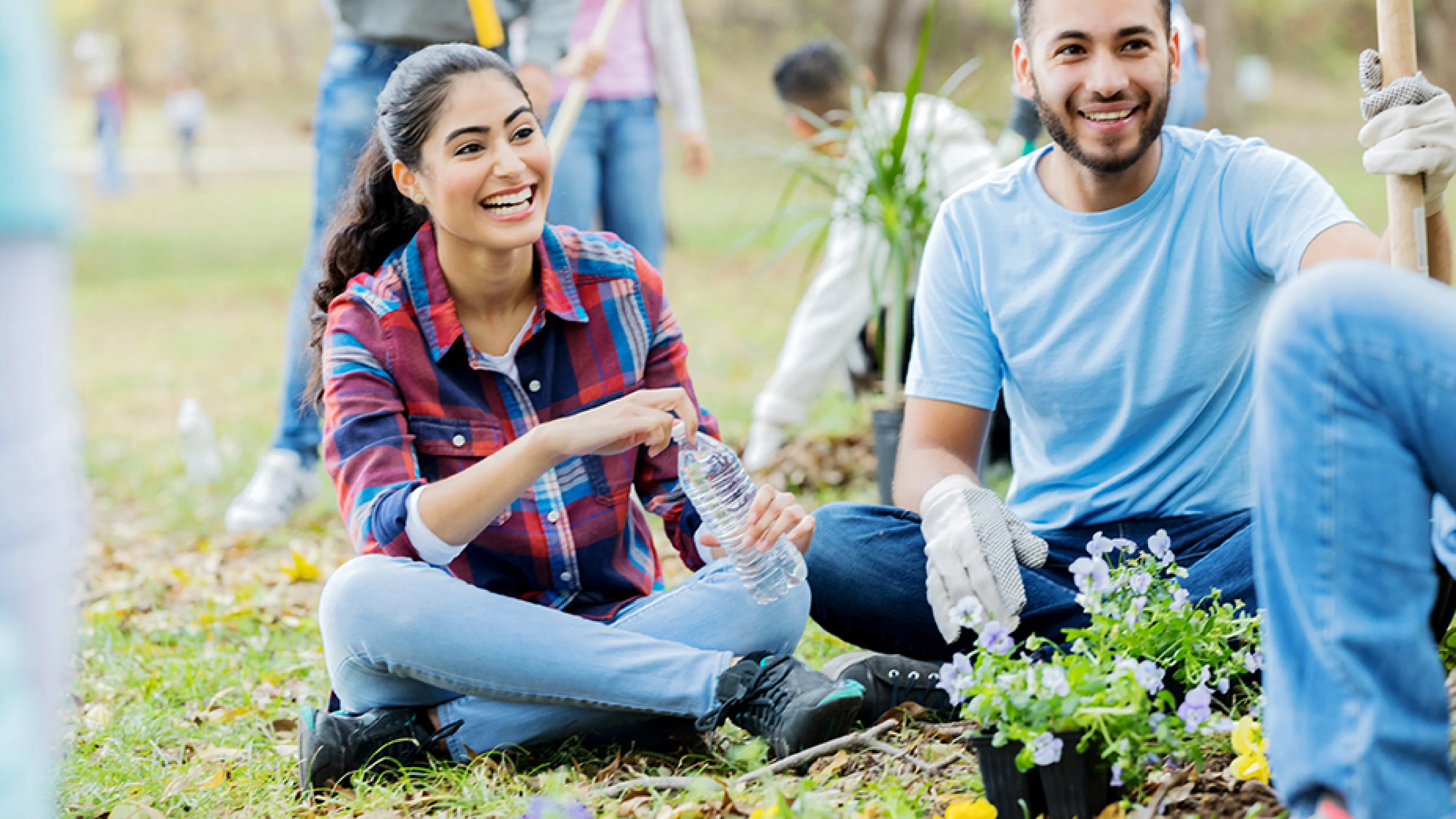 Man and Women helping plant a community garden