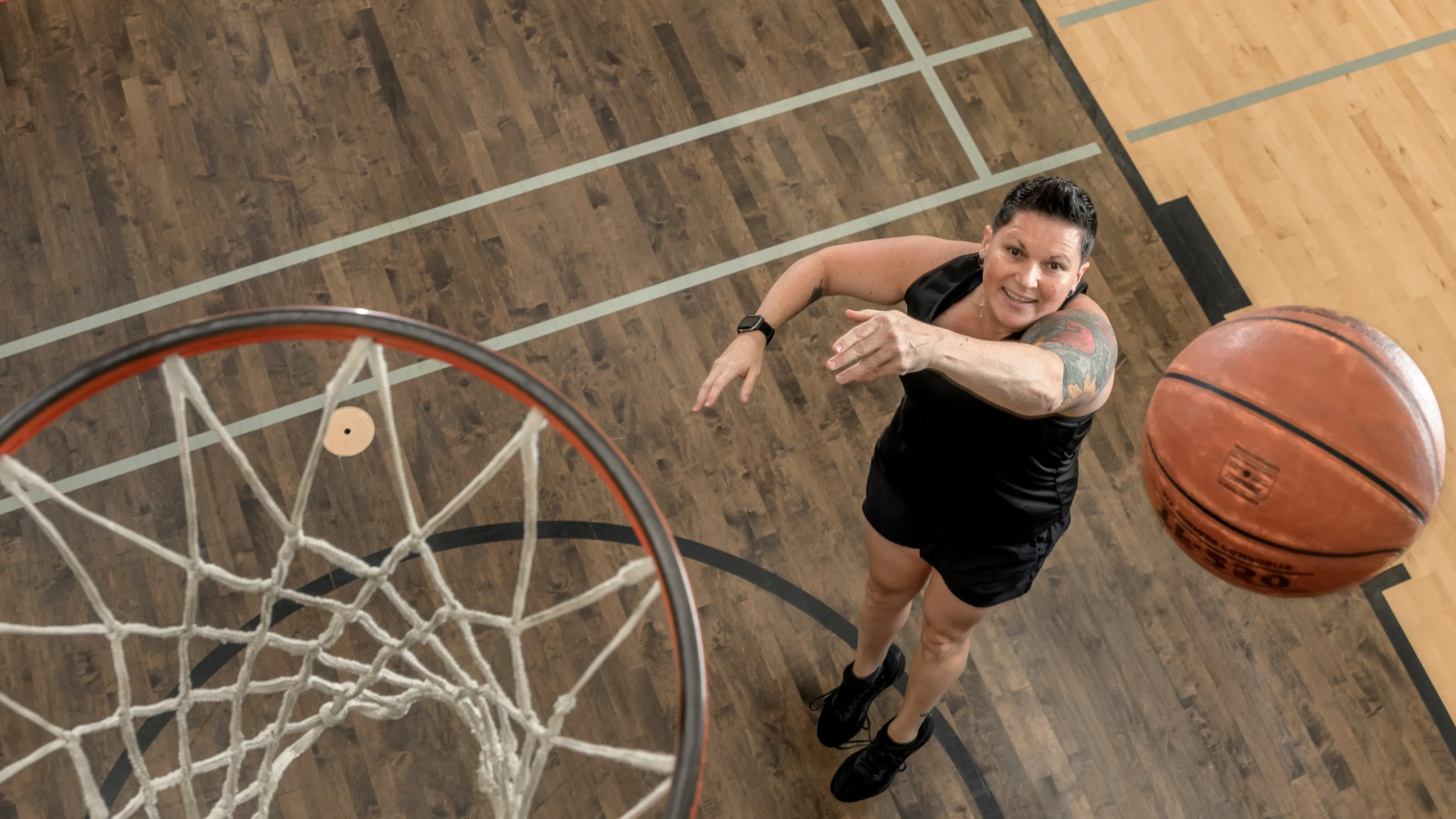 Person shooting a basketball in the hoop