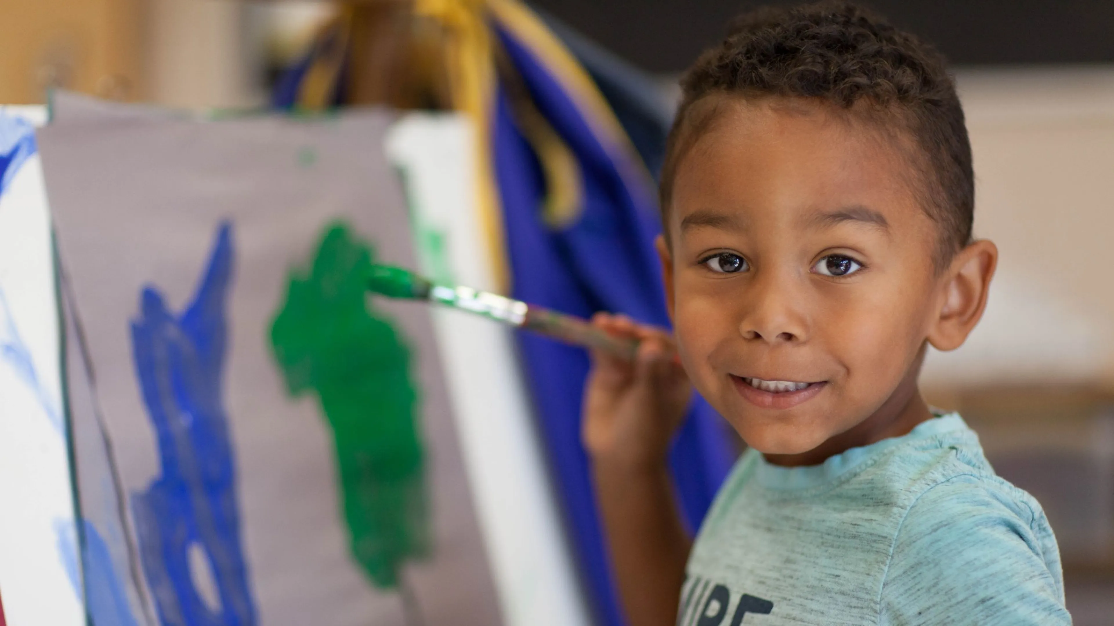 Boy painting at a YMCA Child Care