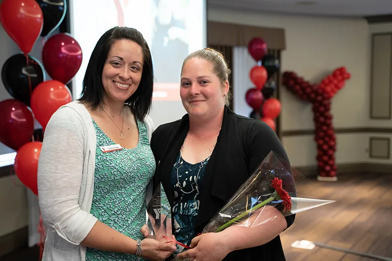 A Y staff member and award recipient pose together.