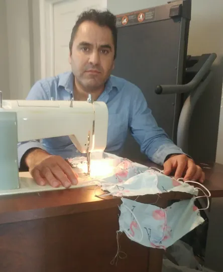 Hasan sews masks as part of the Y's newcomer sewing group.