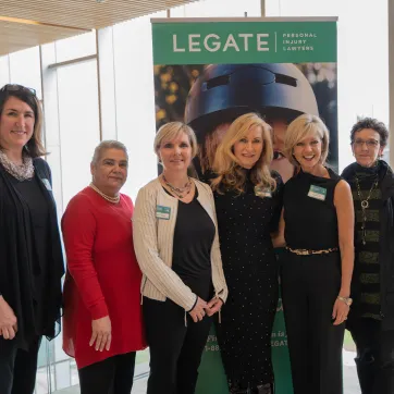 Seven of the 2019 Women of Excellence pose at a media event.