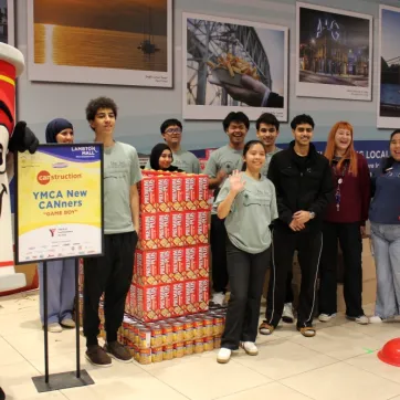 Young adults in front of Game Boy construction