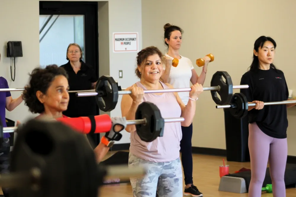 group working out with barbells