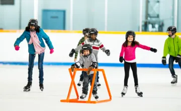 A newcomer family learns to skate in an arena.
